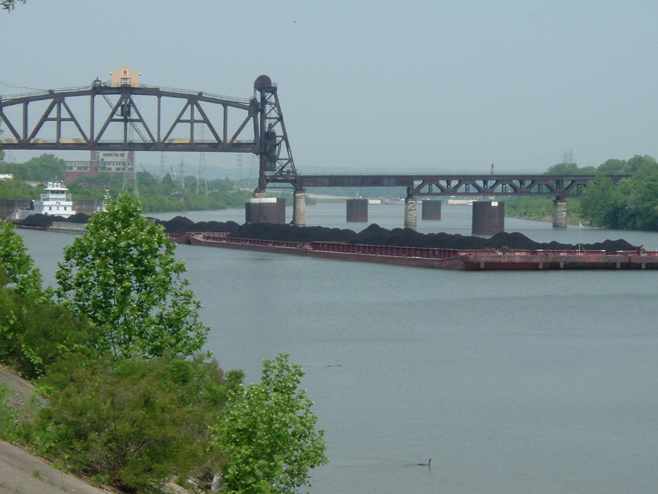 Coal barge tow in the Louisville and Portland Canal today—modern traffic on the 1830 canal route, not a period view