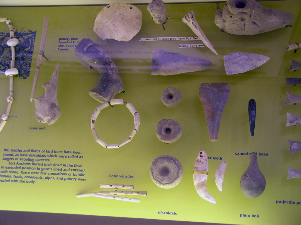 Fort Ancient artifacts (bone awls, beads, pipes, chunkey discoidals) on display in Maysville, Kentucky